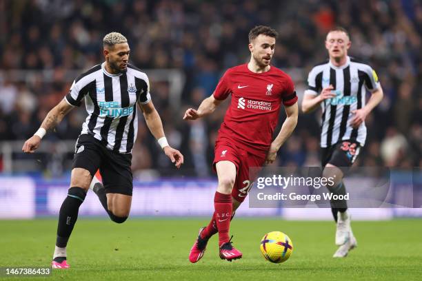 Diogo Jota of Liverpool runs with the ball while under pressure from Joelinton of Newcastle United during the Premier League match between Newcastle...
