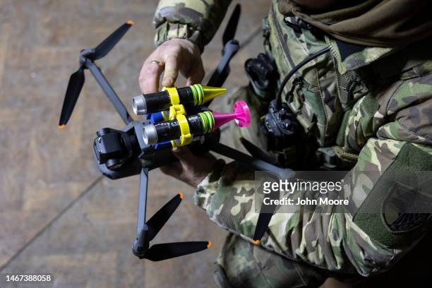 Drone operator with the Ukrainian Army's 93rd Brigade attaches grenades to a DJI Mavic 3 drone on February 18, 2023 in Bakhmut, Ukraine. Ukrainian...
