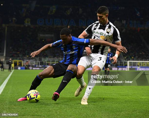 Denzel Dumfries of FC Internazionale competes for the ball with Adam Masina of Udinese Calcio durin the Serie A match between FC Internazionale and...