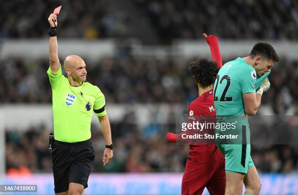 Referee Anthony Taylor shows a red card to goalkeeper Nick Pope of Newcastle United during the Premier League match between Newcastle United and...
