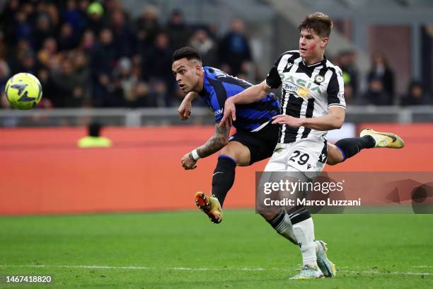 Lautaro Martinez of FC Internazionale scores the team's third goal whilst under pressure from Beto of Udinese Calcio during the Serie A match between...