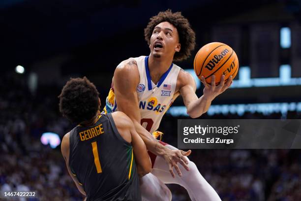 Jalen Wilson of the Kansas Jayhawks lays the ball up over Keyonte George of the Baylor Bears in the first half of the game at Allen Fieldhouse on...