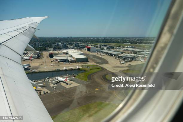 An aerial view of Quantas planes at Sydney Airport on February 18, 2023 in Sydney, Australia. The Sydney Harbour Bridge, which opened March 19, 1932...