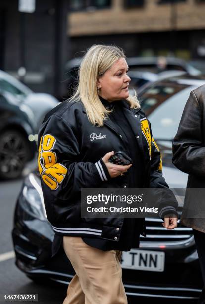 Guest wears college jacket outside Molly Goddard during London Fashion Week February 2023 on February 18, 2023 in London, England.