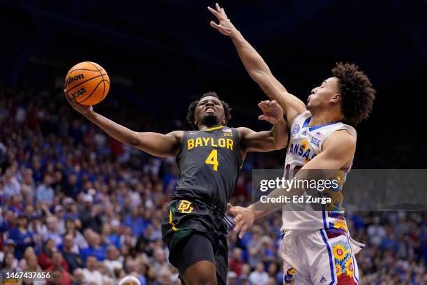 Cryer of the Baylor Bears lays the ball up against Jalen Wilson of the Kansas Jayhawks the second half of the game at Allen Fieldhouse on February...