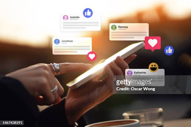 connecting with social media network via smartphone - networking stock-fotos und bilder