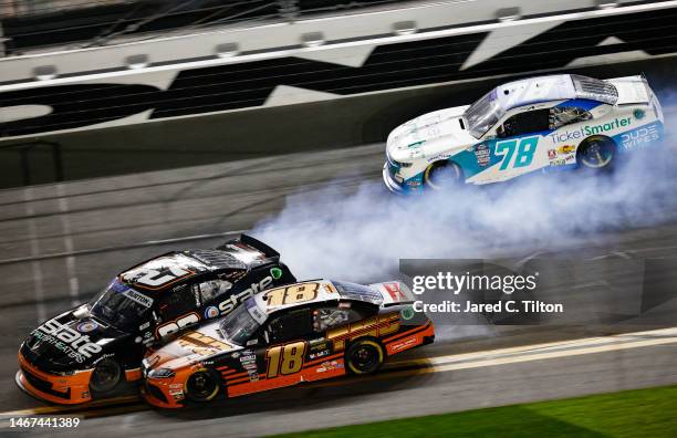 Sammy Smith, driver of the TMC Toyota, and Jeb Burton, driver of the State Water Heaters Chevrolet, spin after an on-track incident during the NASCAR...