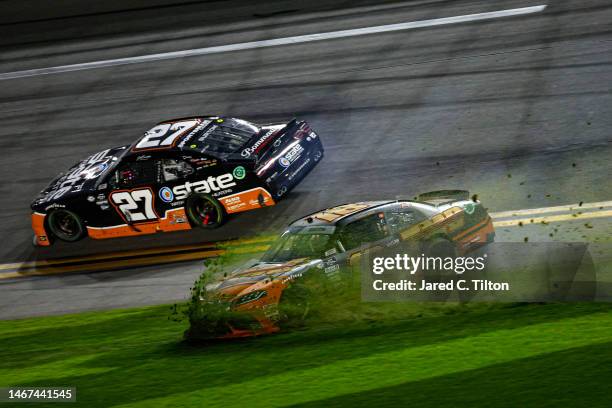 Sammy Smith, driver of the TMC Toyota, spins into the infield grass after an on-track incident with Jeb Burton, driver of the State Water Heaters...
