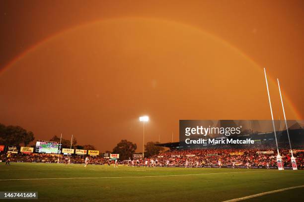 General view of play as a rainbow appears during a storm during the World Club Challenge and NRL Trial Match between the Penrith Panthers and St...