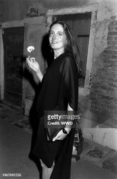Marie Brandolini AKA Countess Marie Brandolini d'Adda di Valmareno holds flower given by attendants during dinner party after 'Made in Milan' film...