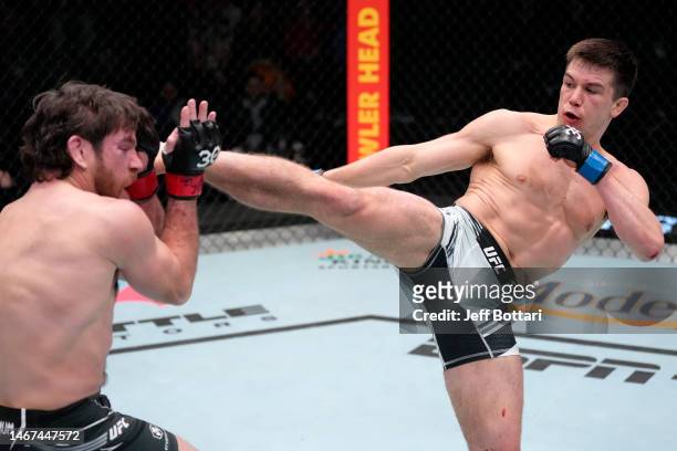 Alexander Hernandez kicks Jim Miller in a lightweight fight during the UFC Fight Night event at UFC APEX on February 18, 2023 in Las Vegas, Nevada.