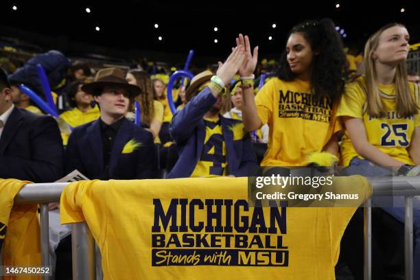 Students in the Michigan student section show support for those affected by the shootings on the Michigan State campus prior to a basketball game...