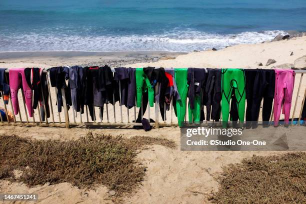 hanging wet suits - carlsbad california stockfoto's en -beelden