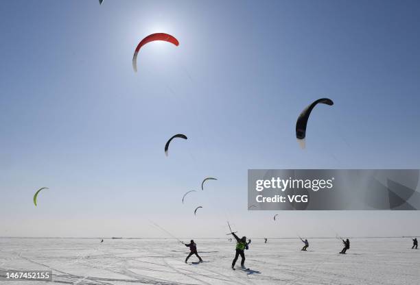 Players compete at a kite skiing competition on a snowfield on February 18, 2023 in Harbin, Heilongjiang Province of China.