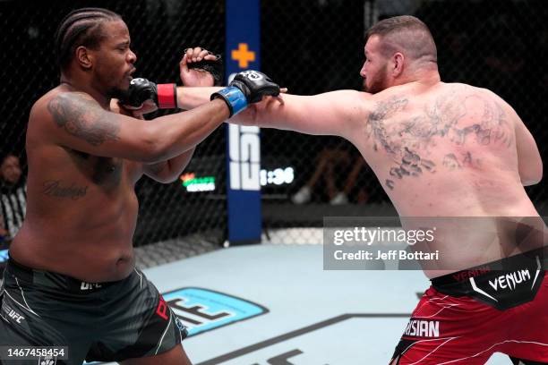 Josh Parisian punches Jamal Pogues in a heavyweight fight during the UFC Fight Night event at UFC APEX on February 18, 2023 in Las Vegas, Nevada.