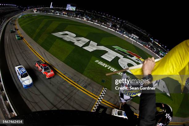 Austin Hill, driver of the Bennett Transportation Chevrolet, and Justin Allgaier, driver of the BRANDT Chevrolet, drive to the checkered flag under...