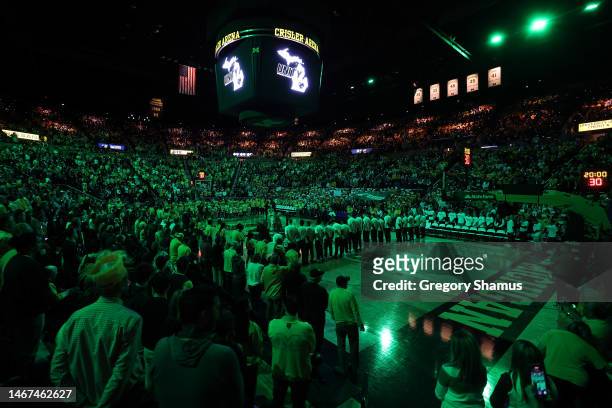 Crisler Arena is lit up green during a moment of silence to support for those affected by the shootings on the Michigan State campus prior to a...