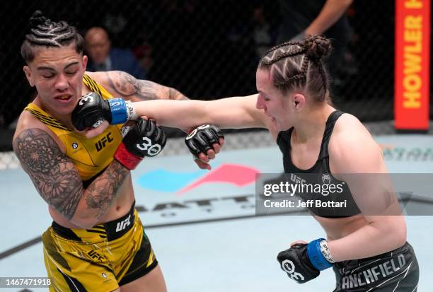 Erin Blanchfield punches Jessica Andrade of Brazil in a flyweight fight during the UFC Fight Night event at UFC APEX on February 18, 2023 in Las...