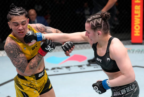 Erin Blanchfield punches Jessica Andrade of Brazil in a flyweight fight during the UFC Fight Night event at UFC APEX on February 18, 2023 in Las...