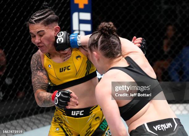 Erin Blanchfield punches Jessica Andrade of Brazil in a flyweight fight during the UFC Fight Night event at UFC APEX on February 18, 2023 in Las...