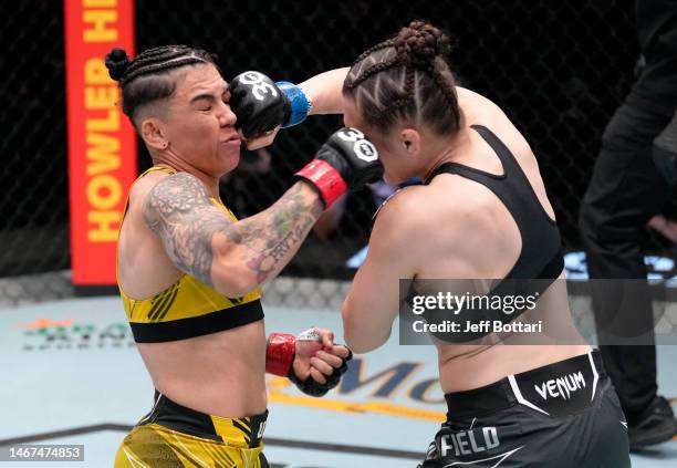 Erin Blanchfield and Jessica Andrade of Brazil trade punches in a flyweight fight during the UFC Fight Night event at UFC APEX on February 18, 2023...