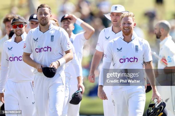 Ben Stokes and Ollie Robinson of England leave the field following day four of the First Test match in the series between New Zealand and England at...