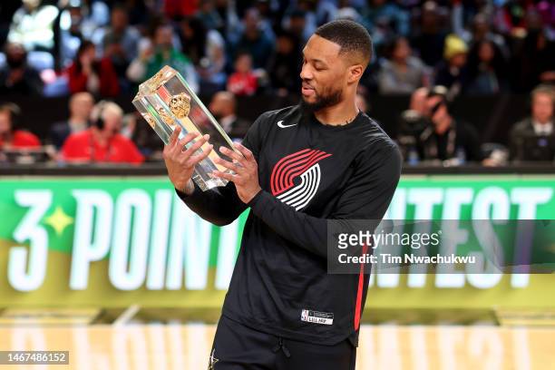 Damian Lillard of the Portland Trail Blazers celebrates with the trophy after winning the 2023 NBA All Star Starry 3-Point Contest at Vivint Arena on...