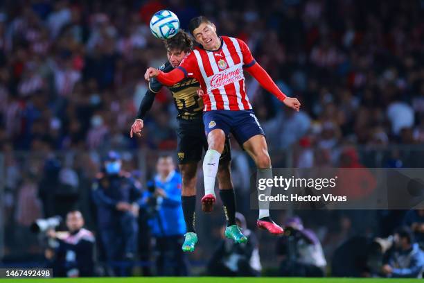 Alek Alvarez of Pumas UNAM battles for possession with Ronaldo Cisneros of Chivas during the 8th round match between Pumas UNAM and Chivas as part of...