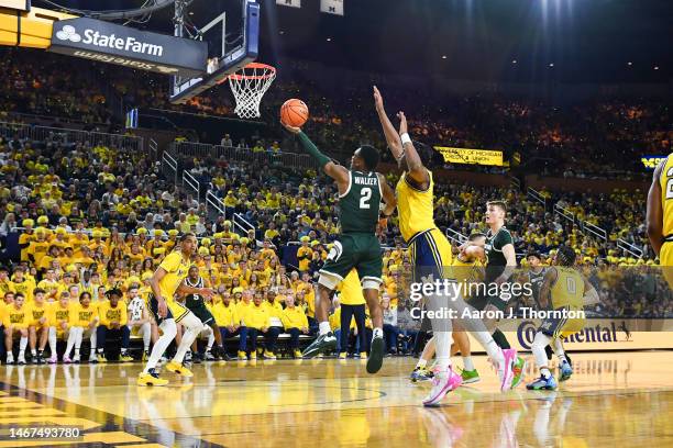 Tyson Walker of the Michigan State Spartans attempts a layup after getting past Dug McDaniel of the Michigan Wolverines during the first half of a...