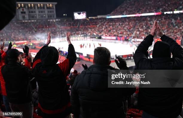 Fans cheer on as the Carolina Hurricanes gather at center ice for their storm surge after the 2023 Navy Federal Credit Union NHL Stadium Series game...