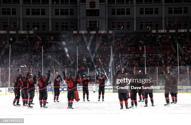 The Carolina Hurricanes gather at center ice for their storm surge after winning the 2023 Navy Federal Credit Union NHL Stadium Series game 4-1...