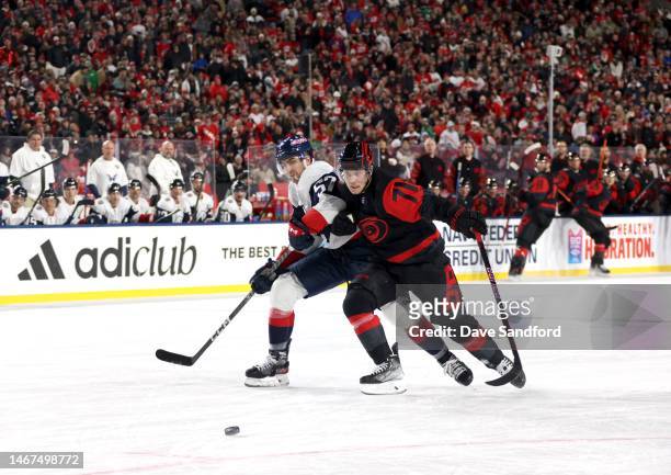 Trevor van Riemsdyk of the Washington Capitals and Jesper Fast of the Carolina Hurricanes vie for positioning to the puck in the third period during...