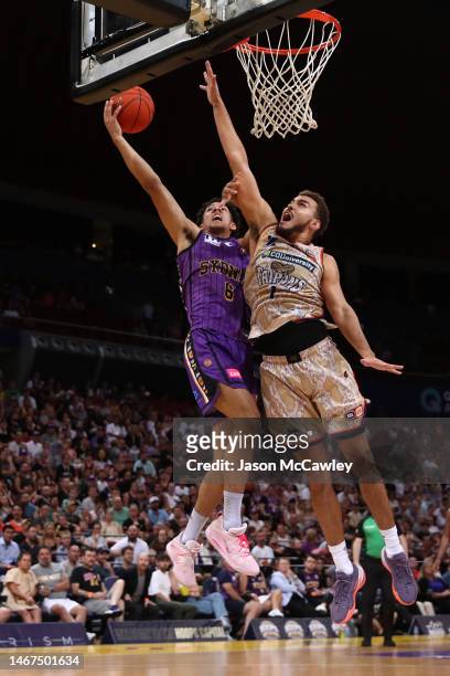 Jaylin Galloway of the Kings drives to the basket under pressure from DJ Hogg of the Taipans during game three of the NBL Semi Final series between...