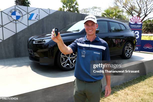 Oliver Hundeboll of Denmark poses with their Hole-In-One award after their hole-in-one on the 13th hole during Day Four of the Thailand Classic at...