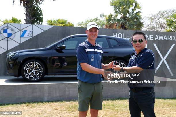 Oliver Hundeboll of Denmark poses with their Hole-In-One award with Preecha Ninatkiattikul, Director of Marketing for BMW during Day Four of the...
