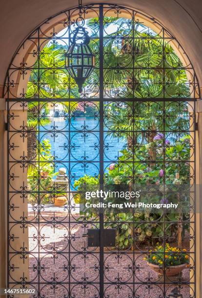 framed door with view, isola san giulio (st. julius island) in lake orta, italy - lake orta stock pictures, royalty-free photos & images