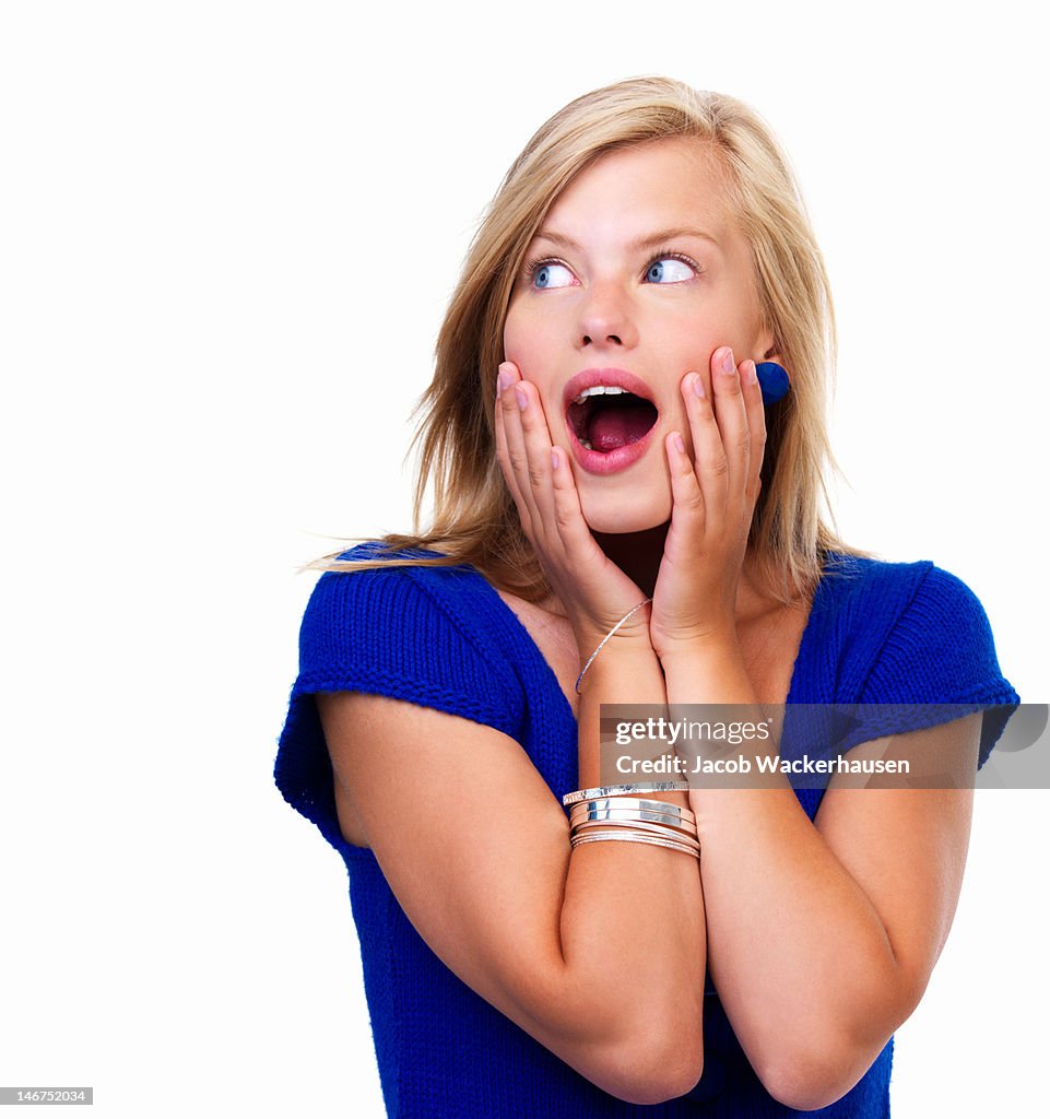 Close-up of a young woman looking surprised on white background