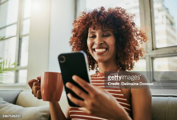 black woman, smartphone and coffee on couch with smile for social media app, web chat and communication in lounge. afican gen z girl, phone ux and texting for networking, blog or post with comic meme - meme text stock pictures, royalty-free photos & images