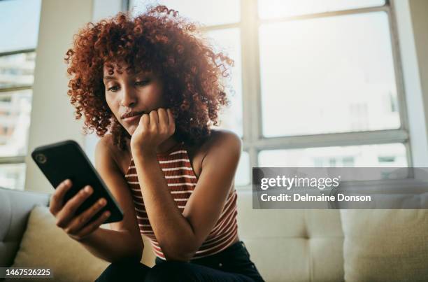 woman, phone and home sofa while online for communication on social media mobile app chat. bored person with smartphone typing email, blog post or search on internet waiting on slow wifi connection - searching phone stock pictures, royalty-free photos & images