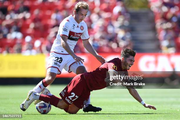 Joshua Cavallo of Adelaide United is injured from a Caleb Nieuwenhof of the Wanderers tackle during the round 17 A-League Men's match between...