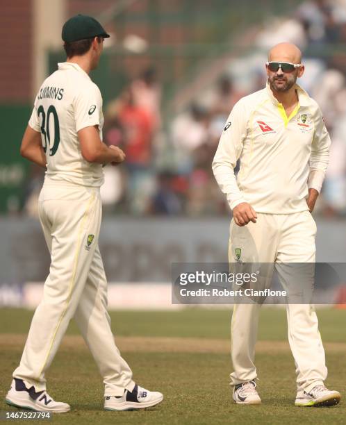 Pat Cummins of Australia speaks with Nathan Lyon during day three of the Second Test match in the series between India and Australia at Arun Jaitley...