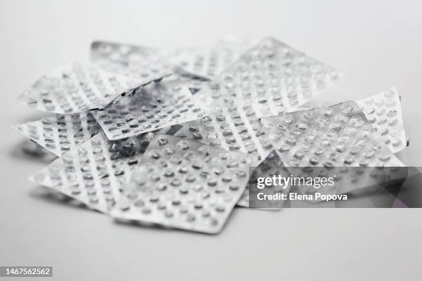 empty silver blister packs of pills background - lysine stock pictures, royalty-free photos & images