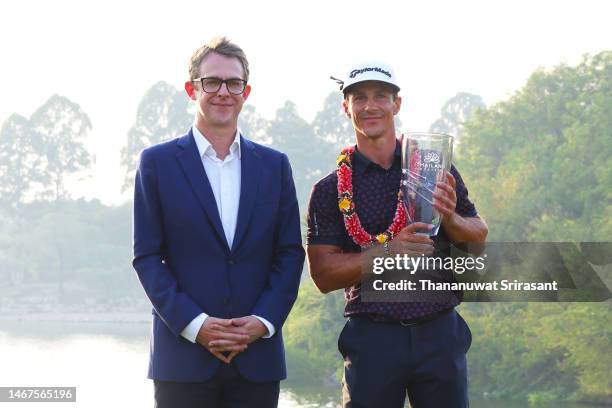 Thorbjorn Olesen of Denmark poses with the Thailand Classic Trophy after winning the Thailand Classic alongside Tom Phillips, Head of Middle East for...