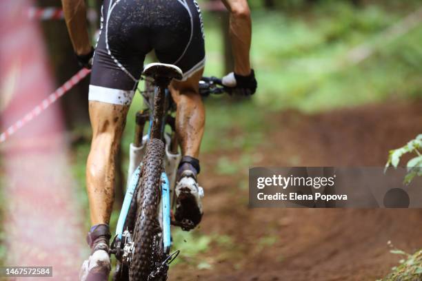 off road cycling race. rear view amateur cyclist training hard mountain biking in a forest track - hip hopper stock pictures, royalty-free photos & images