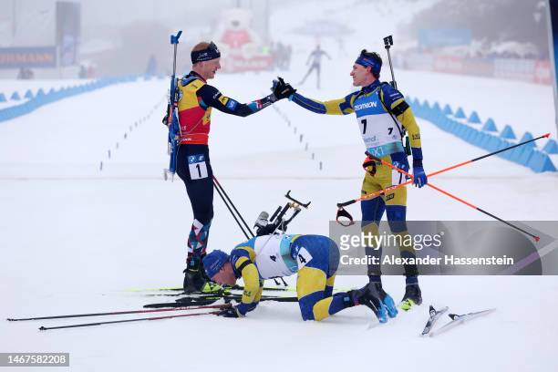 Bronze medalist Johannes Thingnes Boe of Norway congratulates silver medalist Martin Ponsiluoma of Sweden and gold medalist Sebastian Samuelsson of...