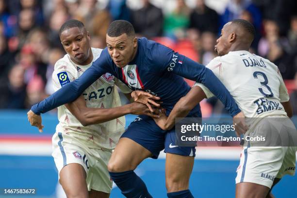 Kylian Mbappé of Paris Saint-Germain bursts past Bafodé Diakité of Lille and Tiago Djaló of Lille to scores his sides first goal during the Paris...