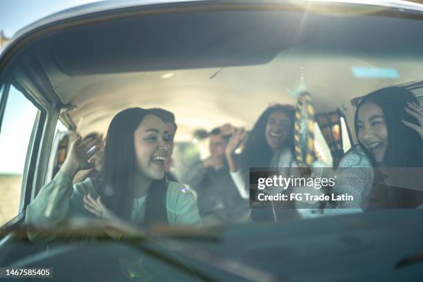 young friends having fun on a road trip in a mini van - mini van stock pictures, royalty-free photos & images