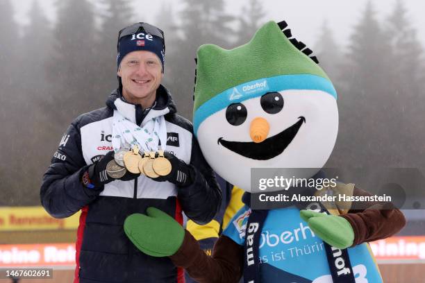 Johannes Thingnes Boe of Norway poses for a photo with mascot Flocke and all their medals during the medal ceremony for the Men 15 km Mass Start at...