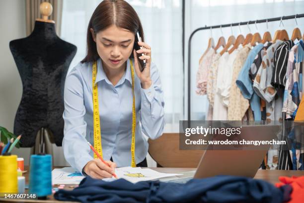 asian female fashion designer using phone and laptop in home. - design studio woman chinese laptop stock pictures, royalty-free photos & images