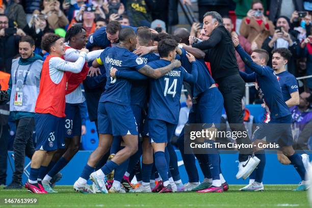 Lionel Messi of Paris Saint-Germain celebrates his last-minute winning goal with teammates as head coach Christophe Galtier joins in the celebrations...